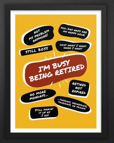 Mounted on a wall next to a bunch of gold balloons is a black wood framed yellow poster print with a large red quote bubble in the center that says, Im Busy Being Retired. Several more quote bubbles surround it with funny retirement quips.
